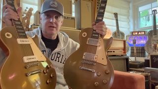 Joe Bonamassa holds up two vintage Les Pauls