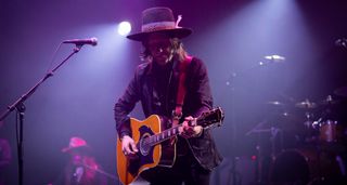Charlie Star performs live with an acoustic guitar.