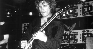 A black-and-white live shot of Berton Averre playing a Les Paul with the Knack