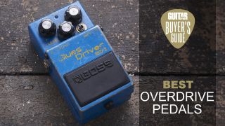 A heavily worn Boss BD-2 Blues Driver overdrive pedal on a wooden floor