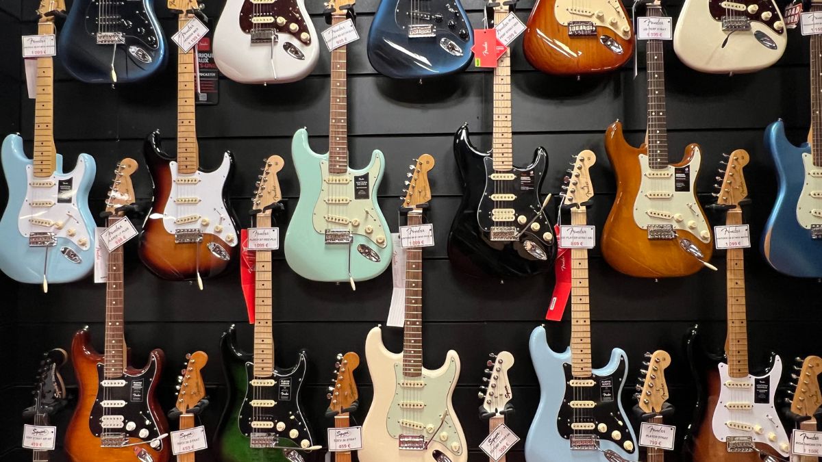 A guitar store wall displaying Fender guitars 